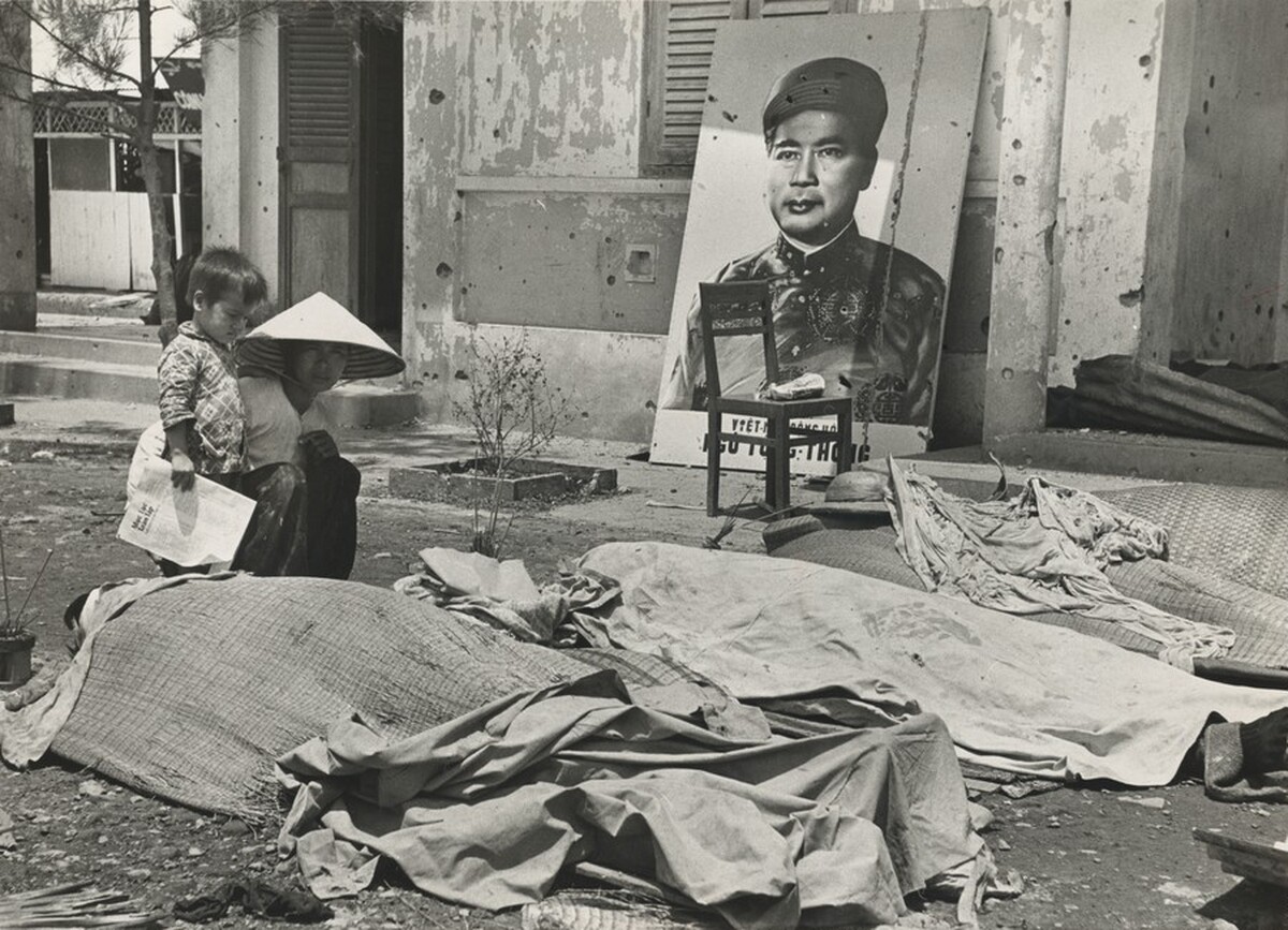 Title from caption on object: “Son Watched as Woman Knelt at the Body of Her Husband”