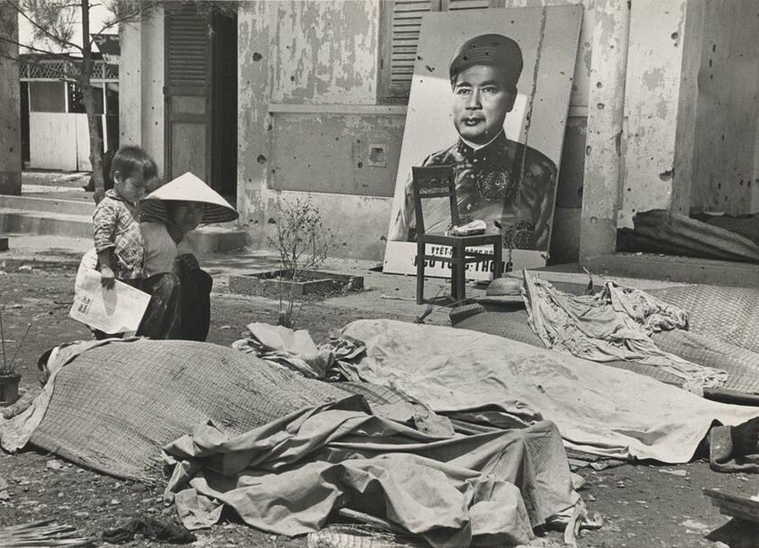 Title from caption on object: “Son Watched as Woman Knelt at the Body of Her Husband”