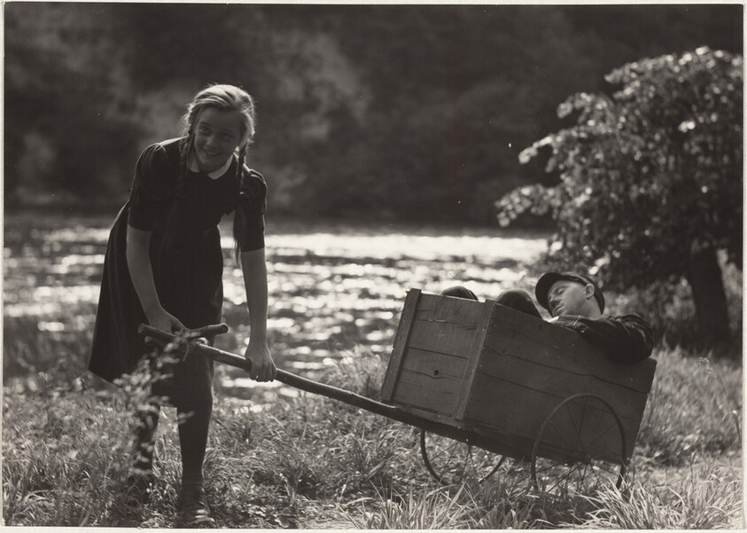 Girl pulling actor in wheelbarrow--Filming "Steibruch"