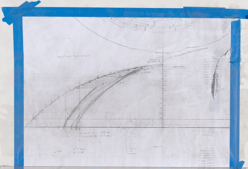 This is a drawing of a technical architectural or engineering design. The drawing features a detailed sketch on a plain sheet of paper with blue tape around the edges. It displays a set of curved lines and horizontal steps. A grid or set of coordinates is subtly visible. There are various annotations, measurements, and numeric data written in a fine script. The drawing has a technical, utilitarian feel, likely created with drafting tools such as pencils and rulers.