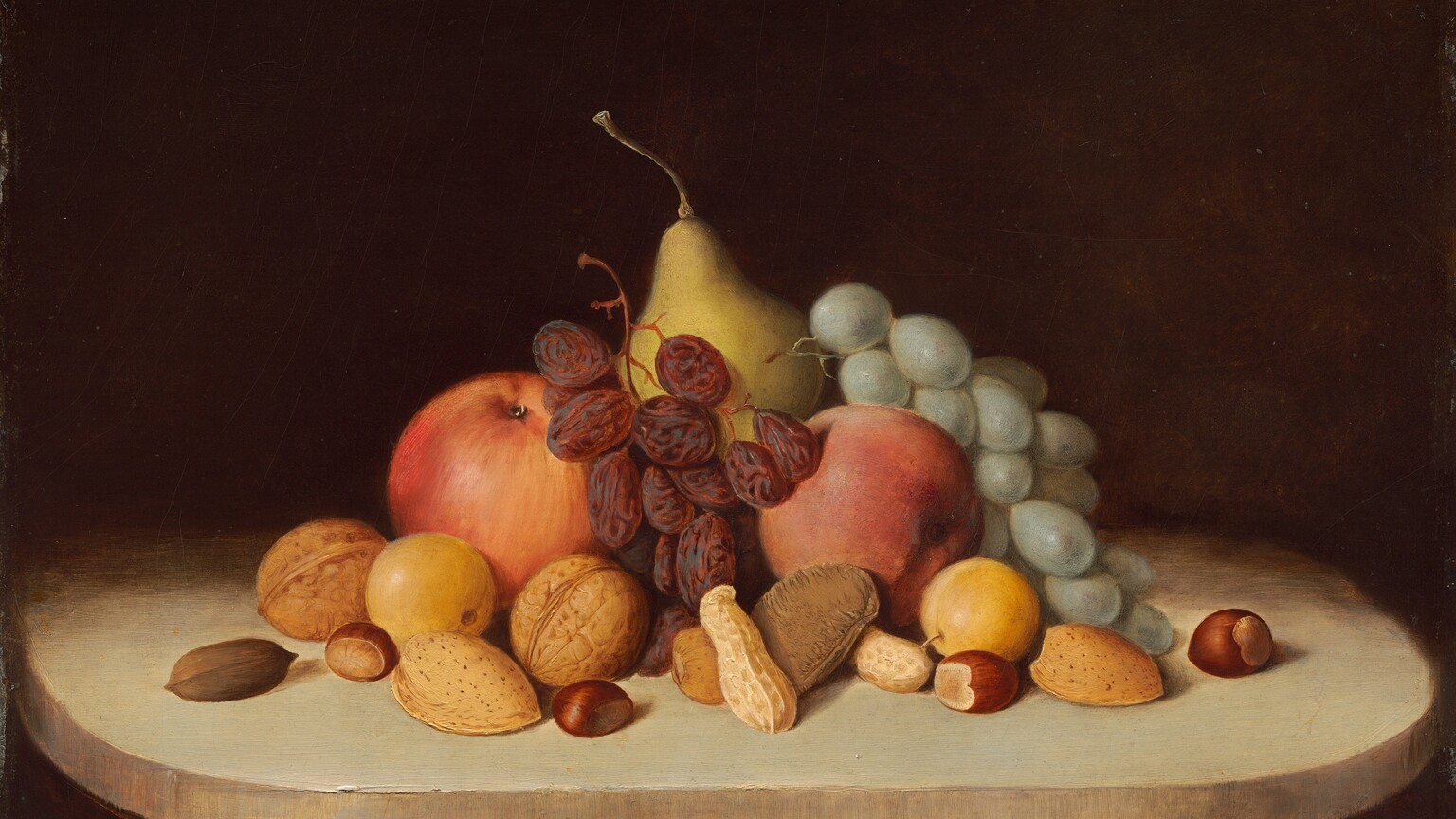 Several pieces of fruit, a bunch of green grapes, a stem of raisins, and several types of nuts in their shells are piled on a putty-brown tabletop or ledge with rounded corners against a dark background in this horizontal still life painting. The food is brightly lit from the front, and we look slightly down onto the table. There are two round red apples and two pieces of small yellow fruit, perhaps quinces, flanking a golden yellow pear at the back center. The bunch of grapes drapes over the fruit to our right and the raisins lie between the apples. Thirteen walnuts, peanuts, almonds, hazelnuts, and perhaps a brazil nut are scattered in a loose band in front of the fruit. The surface on which the still life sits becomes swallowed in shadow behind the fruit, and blends into the dark brown background. The artist signed and dated the work in dark paint in the lower right corner, almost lost in shadow under the ledge: “R.S. Duncanson 1848.”