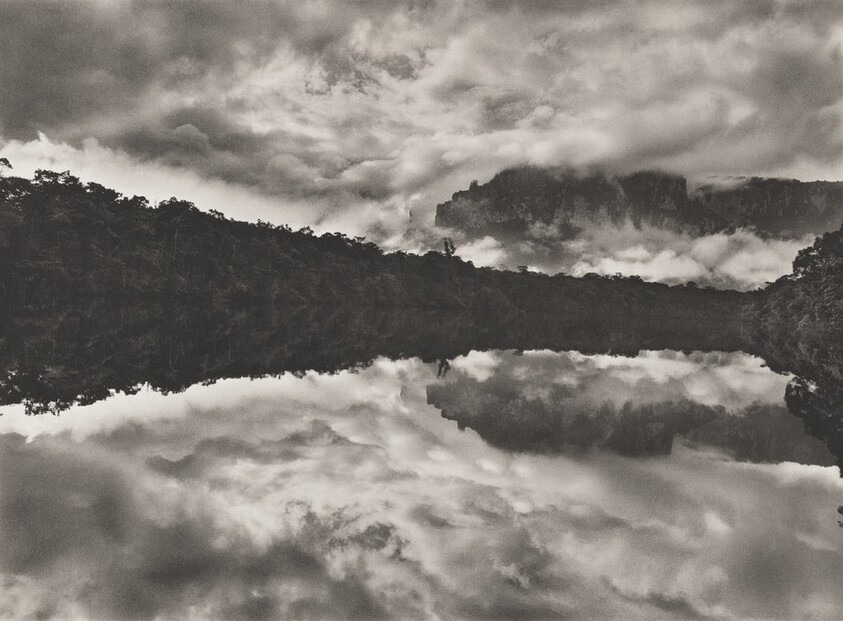 The Akanan River. Mirroring the forest and the Auyantepui in the background, its water is black because of organic tannins released during decomposition. Venezuela.