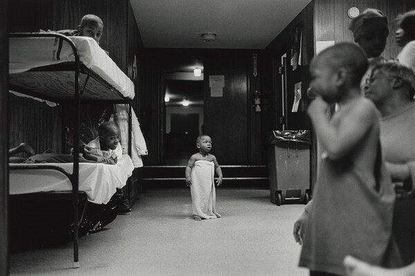 I rarely saw kids in the shelter play. Shelter life is a serious game. This baby waits anxiously for his mama to take him to bed. Olive Branch Mission, Chicago.