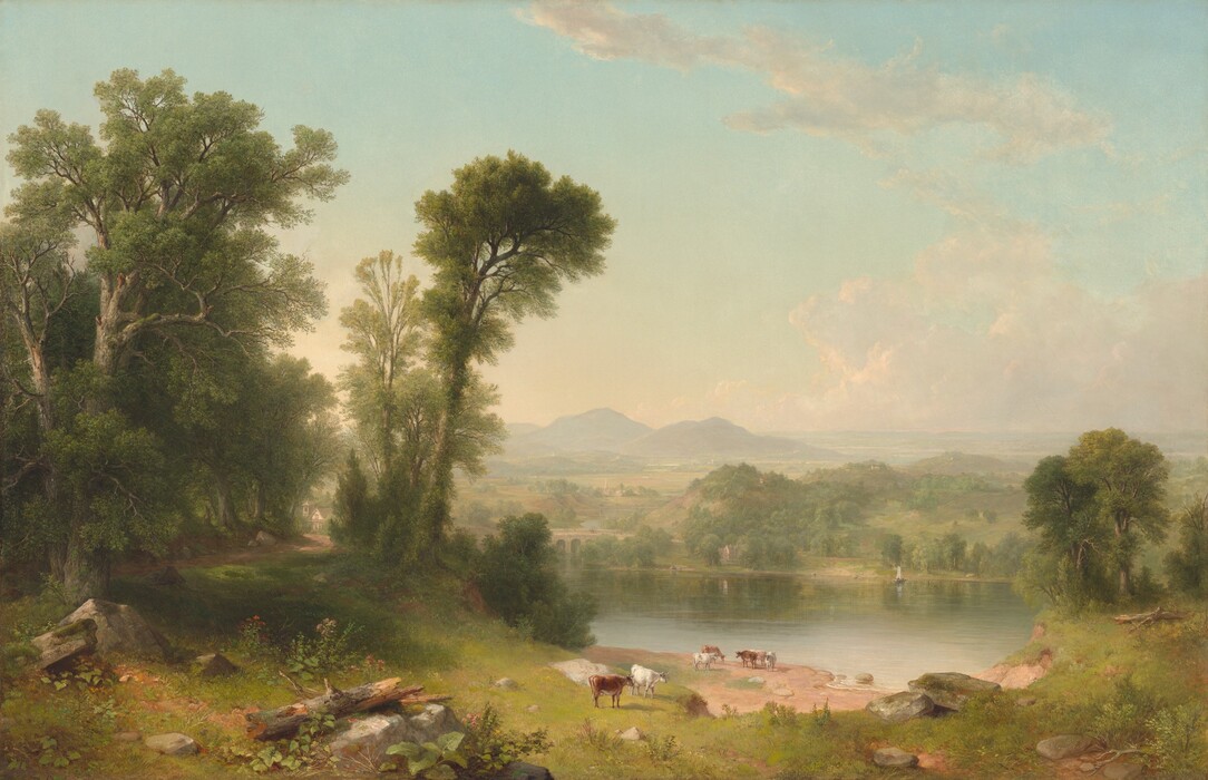 We look sightly down and across a green meadow in front of us at a grove of tall trees to our left next to a shimmering body of water, before a deep view of distant mountains beneath an ice-blue sky in this horizontal landscape. A few slate-gray boulders and fallen tree trunks line the view along the bottom edge of the composition. To our left, tall, moss-green, leafy trees rise nearly the height of the canvas, shading a winding, dirt path that leads to building with white walls and a gray roof in the distance. A tower standing next to the structure suggests this could be a church. The land slopes gently to the water, perhaps a river, where five brown and white cows gather near the sand-colored shoreline at the lower center of the composition. Another pair of cows, one white and one chestnut brown, stand closer to us. The placid surface of the water reflects the pale blue of the sky and the soft green of the tree-covered hill across the river. The river winds under an arched bridge, into the distance to our left. Minuscule buildings and pointed spires dot the landscape that becomes hazy in the distance. The horizon comes about a third of the way up the canvas, and a few wispy, grayish clouds float across the light blue sky. The brushstrokes are blended and the palette dominated by earthy greens, browns, and watery blue, giving the landscape a soft appearance. The artist signed and dated the painting as if he had written his name on a rock near the lower left corner: “ABDurand 1861.”