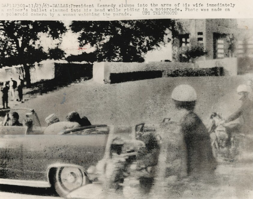 Title from caption on object: “President Kennedy Slumps into the Arms of His Wife...”