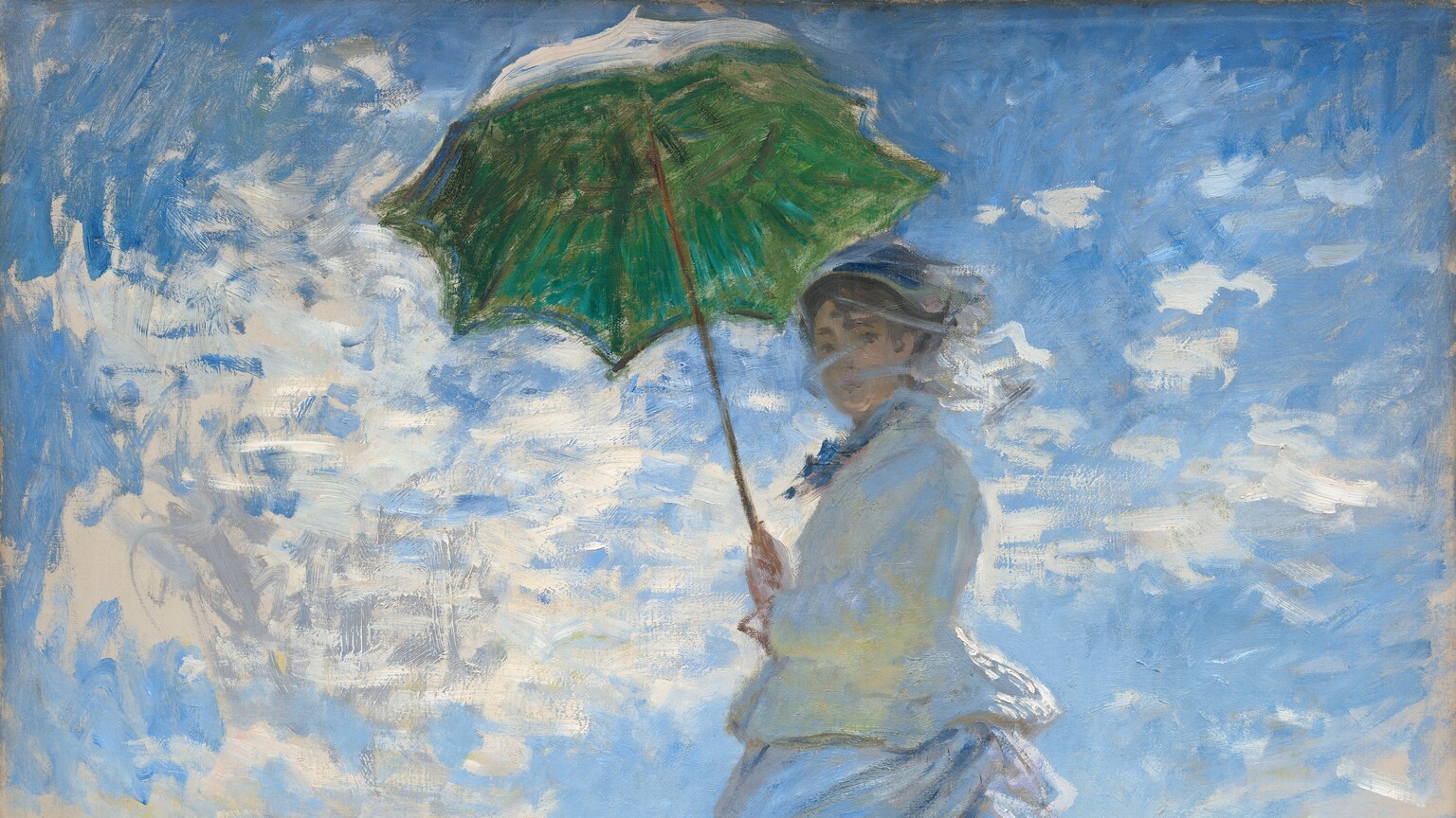 From low on a hillside, we look up at a light-skinned woman and boy standing in tall grass against a sunny blue sky in this vertical painting. The woman stands at the center of the composition, and the moss-green parasol she holds over her head almost brushes the top edge of the canvas. Her body faces our left but she turns her head to look at us. Her long dress is painted largely with strokes of pale blue and gray with a few touches of yellow. Her voluminous skirts swirl around her legs to our left. She holds the parasol with both hands, and her brown hair is covered with a hat. Long strokes of white paint across her face suggest a veil fluttering in the breeze. The tall grass she stands in is dotted with buttercup yellow and plum purple, and she casts a long diagonal shadow along the grass toward us. The young boy seems to stand on the other side of the hill, since the grass and flowers comes up to his waist. He wears a white jacket and pale yellow straw hat. His arms are by his sides, and he seems to look off into the distance to our left. A sunny blue sky behind the people is dotted with bright blue clouds. The painting is created with loose brushstrokes throughout, and they are especially choppy in the clouds. The artist signed and dated the painting in royal-blue letters at the lower right: “Claude Monet 75.”