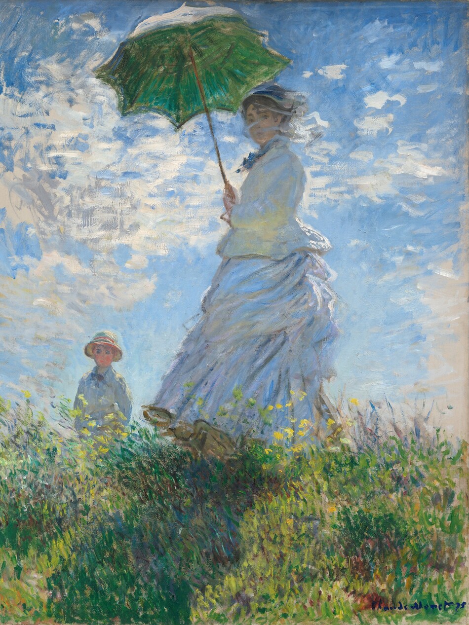 From low on a hillside, we look up at a light-skinned woman and boy standing in tall grass against a sunny blue sky in this vertical painting. The woman stands at the center of the composition, and the moss-green parasol she holds over her head almost brushes the top edge of the canvas. Her body faces our left but she turns her head to look at us. Her long dress is painted largely with strokes of pale blue and gray with a few touches of yellow. Her voluminous skirts swirl around her legs to our left. She holds the parasol with both hands, and her brown hair is covered with a hat. Long strokes of white paint across her face suggest a veil fluttering in the breeze. The tall grass she stands in is dotted with buttercup yellow and plum purple, and she casts a long diagonal shadow along the grass toward us. The young boy seems to stand on the other side of the hill, since the grass and flowers comes up to his waist. He wears a white jacket and pale yellow straw hat. His arms are by his sides, and he seems to look off into the distance to our left. A sunny blue sky behind the people is dotted with bright blue clouds. The painting is created with loose brushstrokes throughout, and they are especially choppy in the clouds. The artist signed and dated the painting in royal-blue letters at the lower right: “Claude Monet 75.”