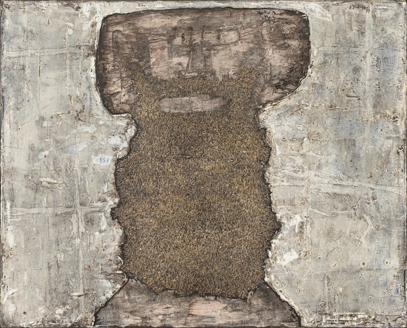 An upright, roughly rectangular, earth-brown and peachy-tan shape with ragged edges is at the center of this horizontal, abstract painting. Slowly we realize this central shape is a stylized face and long beard in the shape of a thick, capital letter T. Blocky ears straight across from rectangular eyes and a sketchily drawn nose create the wide crossbeam on the T. There is a peach smudge for the mouth and another band along the bottom of the painting, presumably representing skin on the chest. The rest of the central, dark area, a beard, is textured with sand and clay brown. The areas around the face and beard are streaked and daubed in with fog gray, pearl white, and pale tan. The artist signed and dated the work in the upper right corner, “J. Dubuffet 59.”