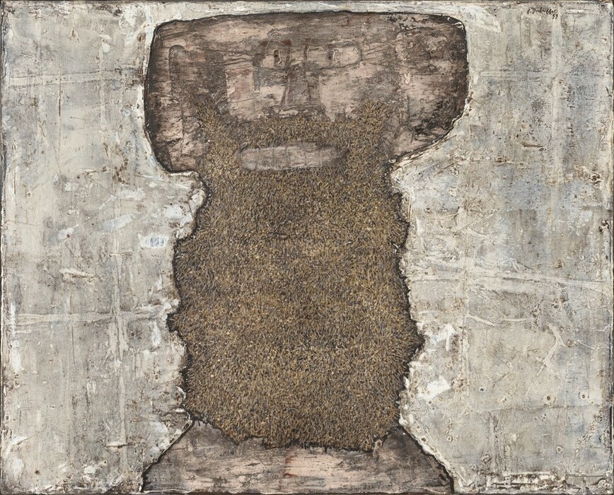 An upright, roughly rectangular, earth-brown and peachy-tan shape with ragged edges is at the center of this horizontal, abstract painting. Slowly we realize this central shape is a stylized face and long beard in the shape of a thick, capital letter T. Blocky ears straight across from rectangular eyes and a sketchily drawn nose create the wide crossbeam on the T. There is a peach smudge for the mouth and another band along the bottom of the painting, presumably representing skin on the chest. The rest of the central, dark area, a beard, is textured with sand and clay brown. The areas around the face and beard are streaked and daubed in with fog gray, pearl white, and pale tan. The artist signed and dated the work in the upper right corner, “J. Dubuffet 59.”