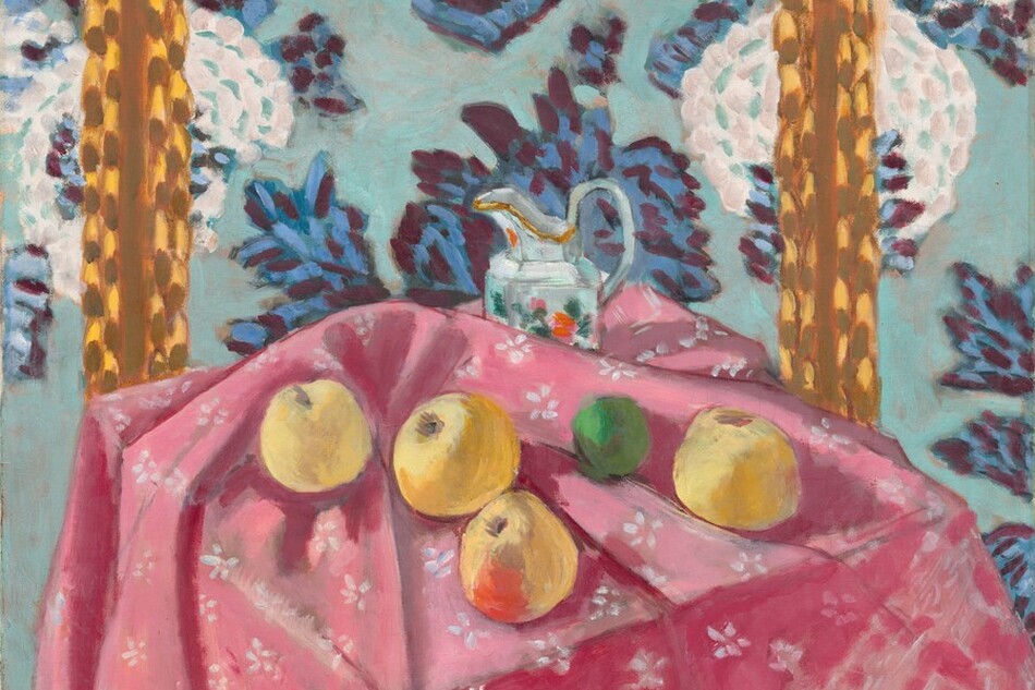 Four yellow apples, a lime, and a ceramic pitcher are loosely arranged across a tabletop covered with a carnation-pink cloth patterned with white flowers in this almost square, stylized still life painting. The scene is loosely painted with visible brushstrokes in saturated colors throughout. We look slightly down onto the front corner of the table, where the canary-yellow apples sit in the folds of the tablecloth. The apple closest to us at the corner of the table has a scarlet-red patch on the side facing us. Between the two rightmost apples, the lime is painted in shamrock and fern green. The cloth is bunched up just behind the apples to partially obscure the pitcher sitting near the back of the table. The pitcher is painted with swipes and patches of white, aquamarine blue, and silver gray with gold highlights along its spout. Daubs of pine green, rose pink, and flame red suggest a floral decoration on its side. The wall beyond the table fills the height of the composition, and is scattered with white flowers layered over an aquamarine-blue background. The blossoms seem oversized, each the size of a blown-up balloon. Other leafy forms painted with sapphire blue and plum purple could be more flowers or leaves. Two vertical stripes to the left and right behind the table are made up of strokes and daubs of caramel brown over honey yellow. The artist signed the lower right, “Henri-Matisse.”