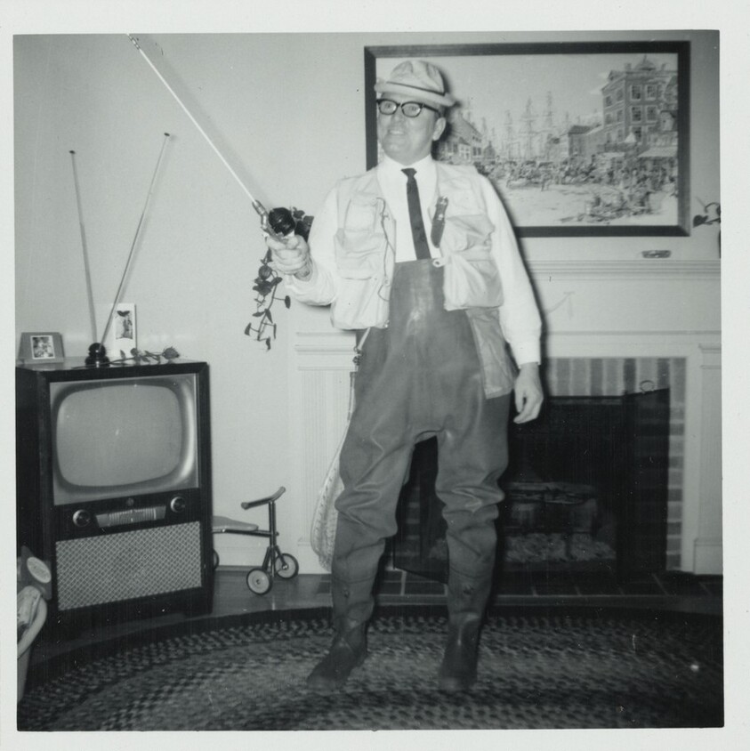 Untitled (Man in living room with fishing pole)
