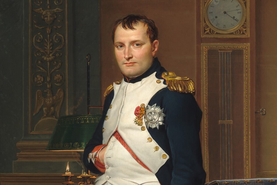 A man with pale peach skin and dark hair wears a military uniform and stands in front of a desk in this vertical portrait painting. He nearly fills the composition so seems close to us, and he looks directly at us. His body is angled slightly to our left and he tucks his right hand, on our left, flat against his chest between the buttons of his jacket. His navy-blue waistcoat is white along the front where it is fastened with brass buttons along his chest. The jacket has red cuffs, gold epaulets on the shoulders, and three medals affixed to the chest. White britches end just below the knee, and white stockings covering his calves are wrinkled at the ankle above black shoes with brass buckles. A candle burns low in a lamp on an ornately carved and gilded desk behind the man. Books and papers are piled on the desk to our right. More papers and a thin sword rest on a chair in front of the desk to our right. The chair is also carved and gilded, and is upholstered with scarlet-red fabric decorated with gold bees. The legs of the chair push back the forest-green carpet underfoot. A tall clock stands on the wall opposite us and reads 4:13. A few capital letters are written on a scroll of paper on the chair, “COD.” The artist’s name is also written as if printed on a scroll of paper on the floor behind the desk to our left: “LVD.CI.DAVID OPVS 1812.”