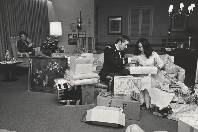 Lieutenant (West Point graduate) and his Vietnamese bride-to-be unwrapping presents. His parents refused to attend.
