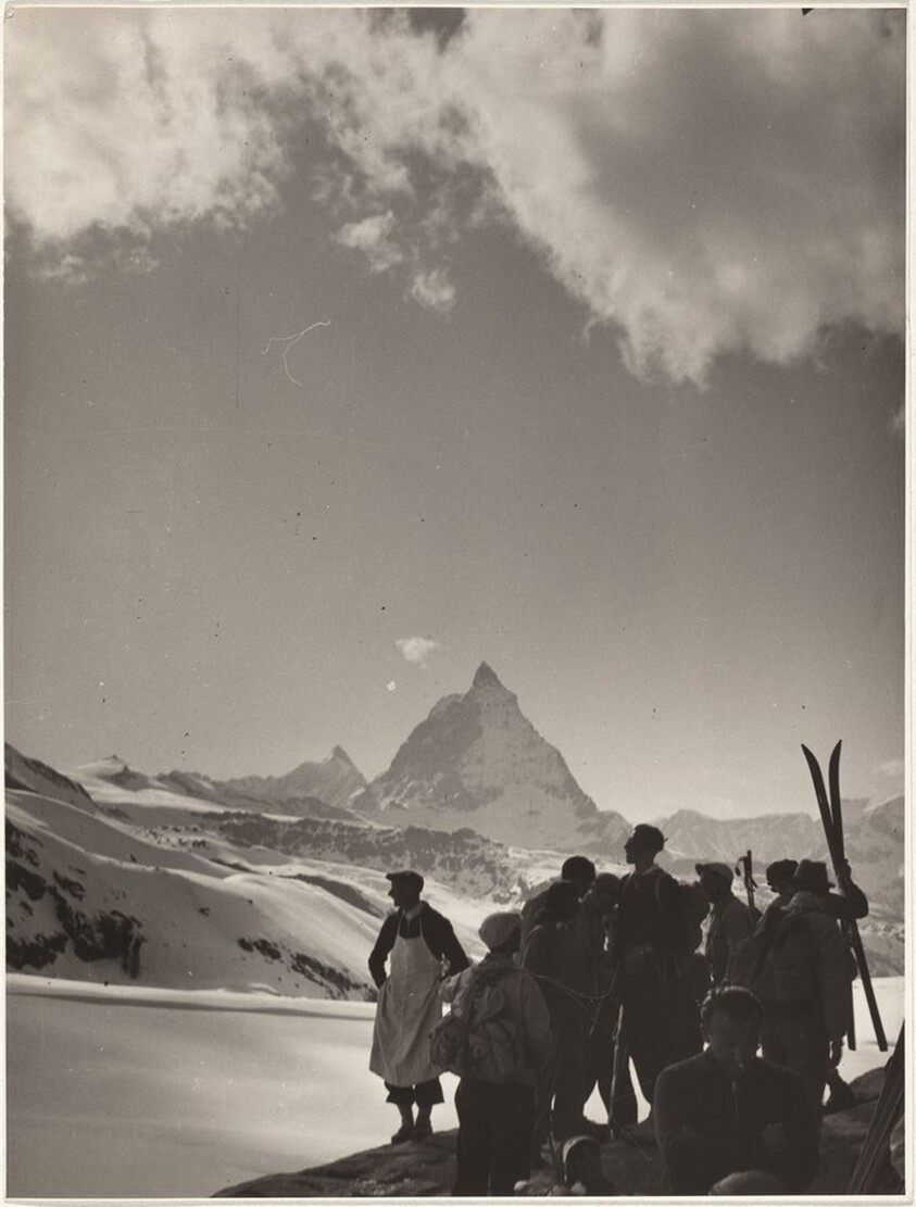 Skiers looking at distant mountains--Sports