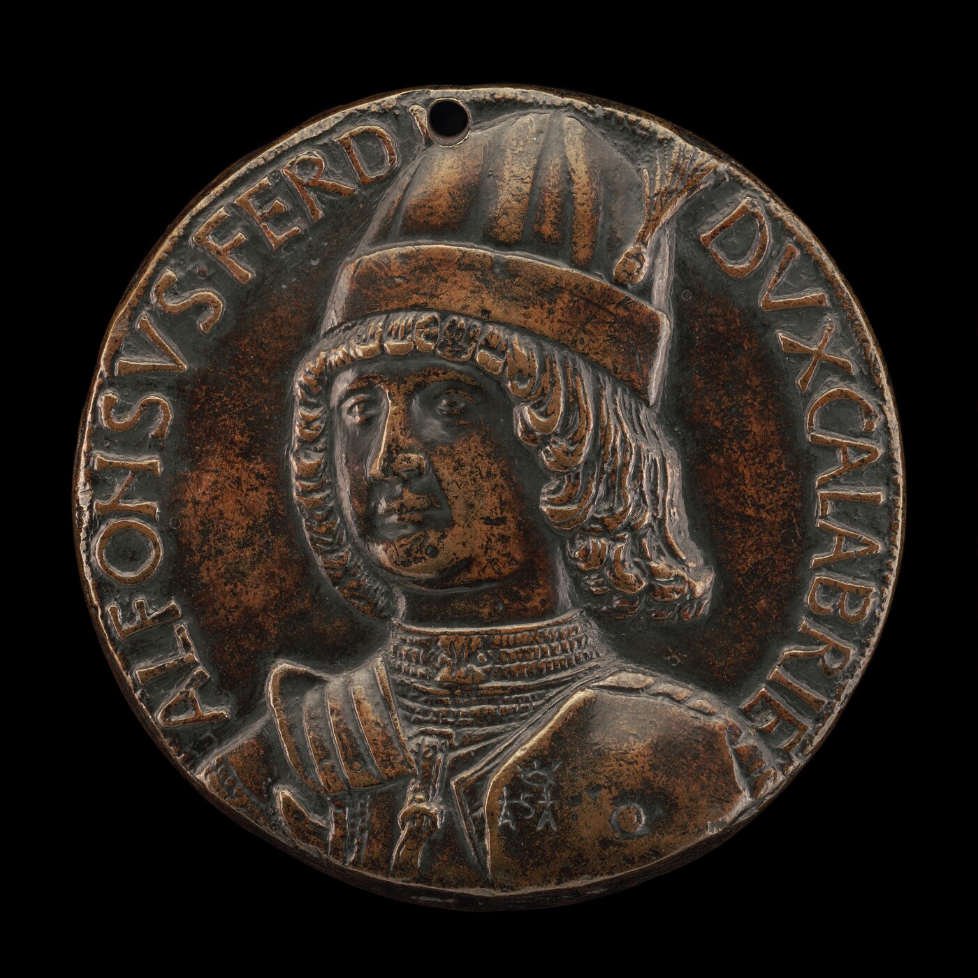 The sculpture is a round bronze medal with a relief portrait of a man in profile. The subject is wearing a hat with a crest and ornate collar, suggesting historical or noble significance. The bronze material gives the sculpture a dark brown color with subtle highlights. It is small and detailed, with text encircling the portrait for contextual identification.