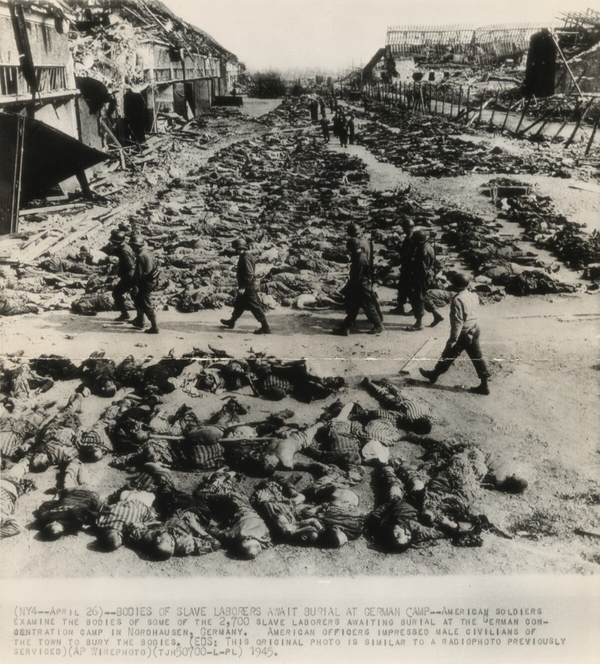 Title from caption on object: “Bodies of Slave Laborers Await Burial at German Camp”