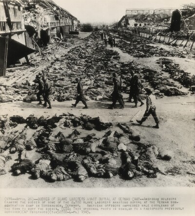 Title from caption on object: “Bodies of Slave Laborers Await Burial at German Camp”