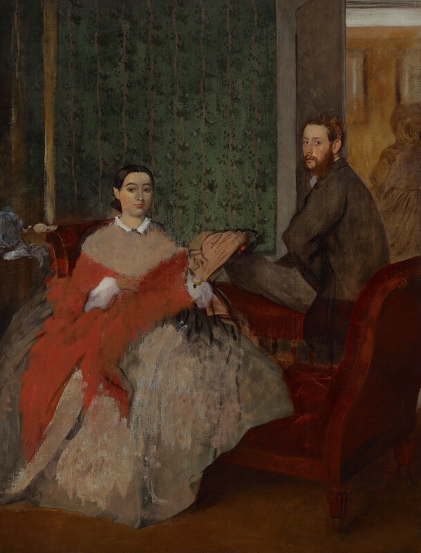 A man and woman, both with pale, peachy skin, sit on opposite sides of a burgundy-red, low-backed sofa in a room wallpapered with a striped, floral pattern in this vertical painting. To our left, the woman sits with her body facing us, and she looks at us with dark eyes under dark, arched brows. She has an oval face, a straight nose, and her coral-pink lips are closed. The woman’s dark brown hair is parted down the middle, and smoothed and pulled back to the base of her head. Her pinkish-tan dress has a narrow white collar and a full, billowing skirt. A loosely painted, crimson-red shawl wraps around her torso and is pulled over white, puffy sleeves. Also loosely painted, a shell-shaped, tan object to our right could be a fan held in her left hand. To our right and on the far side of the piece of furniture, the man sits on the low back of the chaise-longue, his left knee bent so that thigh, closer to us, rests along the back of the sofa. He turns his face to look at us from the corners of his eyes. He has a rounded nose, and his full, pink lips are closed. He has an auburn-brown beard and his short hair is tousled. He wears a brown coat and charcoal-gray slacks. He rests the hand closer to us against his hip so his elbow juts toward us. To either side of the people and nearly spanning the width of the painting, the arms of the chaise curve upward to about the height of the woman’s shoulders. A loosely painted, ball-like form next to the left arm of the chaise could be a hat or other object on a side table. The wall behind the people extends from the left edge of the painting to just behind the man, and is patterned with evergreen-colored dots to create floral patterns along vertical beige-colored stripes, all against a moss-green background. A golden yellow, vertical line near the left edge of the painting may be the frame of a mirror or painting. Beyond the man, to our right, a doorway opens to another room with mustard-yellow walls with white molding along the ceiling. A ghostly outline in ash-gray suggests a woman wearing a full skirt, long sleeved jacket, and hat in the room beyond. The paint in some areas is thinly applied or scraped away, especially in the people’s clothing.