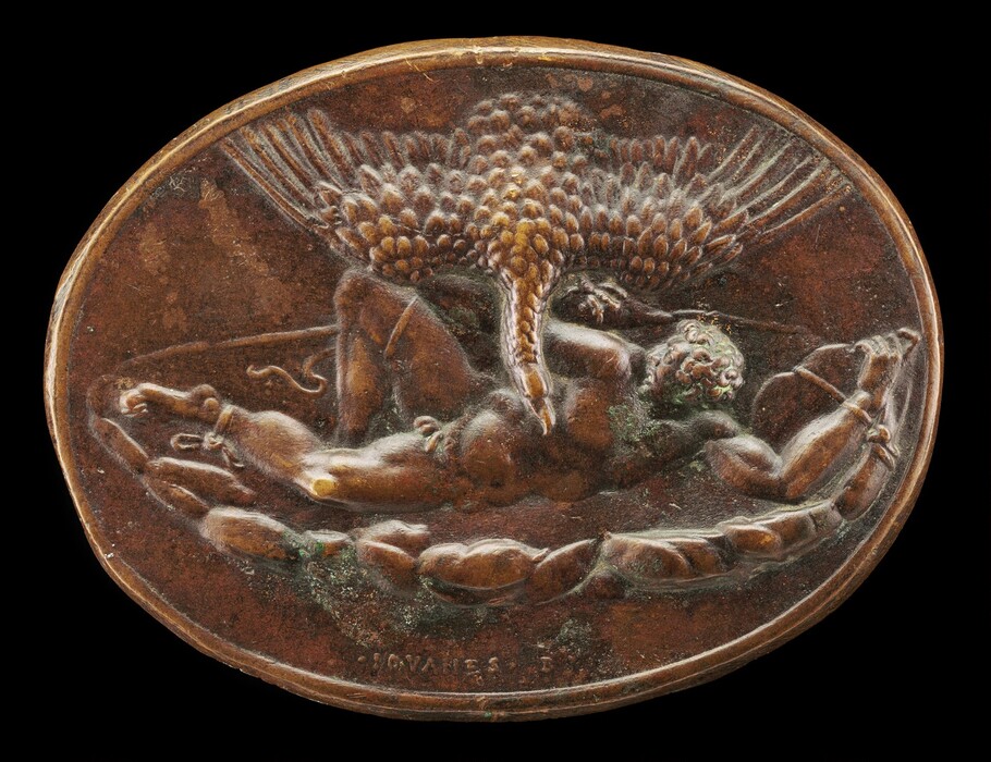 The sculpture depicts a figure that appears to be lying on the ground, with a large bird hovering above them. The bird is positioned centrally within the sculpture, its wings outstretched, showing its feathers in detail. The figure beneath the bird is in a reclined position, with its limbs extended and head turned toward one side, conveying a sense of motion or struggle. The sculpture is crafted from a material that looks like bronze, providing a brown coloration with hints of an aged patina visible in some areas. It is presented within an oval frame which lacks further background elements.