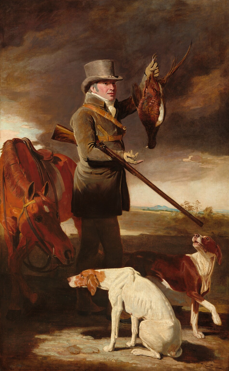 This painting shows a man holding a pheasant by its legs in his raised left hand, his right arm supporting a long rifle. The man is turned to the right, and he is wearing a tall grey top hat, a long, gray-brown coat, dark pants, and boots. He has fair skin, pink cheeks, and a slight smile on his pink lips. Gray hair is partially visible beneath his hat. A red horse is to his left with its head lowered, and two brown-and-white dogs are at his feet. The background is a sky with swirling clouds in shades of brown and gray, with distant blue hills visible beyond the brown landscape.