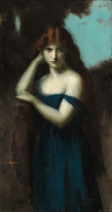 Shown from the knees up, a woman with pale, almost white-colored skin looks out at us in this hazy, shadowy vertical painting. The setting is painted with smudged browns around a corner of electric-blue sky at the upper right. The woman rests her right elbow, to our left, up on a surface, presumably a rocky ledge, but details are difficult to make out. Her shoulders are angled slightly to our left, but her face is turned to us. She looks out with dark eyes under lowered brows. At first glance she seems to look at us, but a closer look shows that outlining around her irises and eyelids indicates that she looks slightly up and to our right. Her lips are closed, and her chin is tucked back. Copper-red hair is parted down the middle and gleams along the center part before falling quickly into shadow as it reaches down past her hips. She rests her chin against a closed fist of the arm propped on the ledge. The other hand sits next to the elbow on the ledge. One sapphire-blue sleeve falls off her sleeveless, low-cut dress, which falls straight off the bottom edge of the painting. The scene is painted with blended strokes, including the woman’s features, so has a soft, ethereal look. The artist signed the brown area near the lower left with honey-yellow paint, “J J HENNER.”