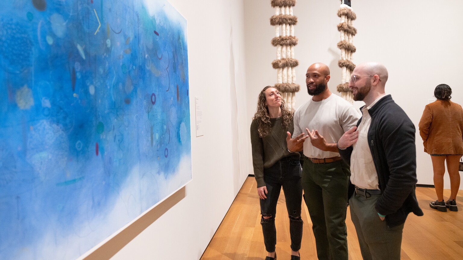 Visitors look at a painting in the National Gallery of Art.