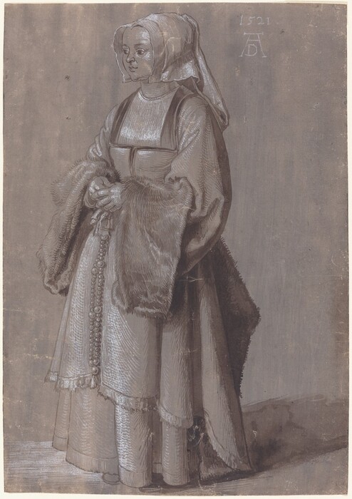 A woman stands angled to and looking off to the left in this vertical, full-length drawing, which was created with brown and white ink and shaded with washes of the same color on smoky purple-colored paper. The woman has a heart-shaped face with a short, rounded nose, full lips, and a bulb-shaped chin. Her head is covered with a white cloth that drapes to chin length at the sides and falls down her back. The square neckline of her bodice is low, but her chest is covered with a white cloth. The voluminous sleeves are lined with wide, long bands of fur along the cuffs, and she holds her hands clasped in front of her waist. A beaded rosary hangs from her waist, and the deep folds of her heavy skirts fall almost to the floor. The artist signed the drawing near the upper right corner with a capital letter D tucked between the long legs of a letter A. The monogram is below the date, 1521.