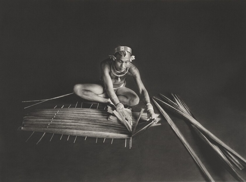 Teureum, sikeirei and leader of the Mentawai clan. This shaman is preparing a filter for sago, with the leaves of this same tree. Siberut Island. West Sumatra. Indonesia.