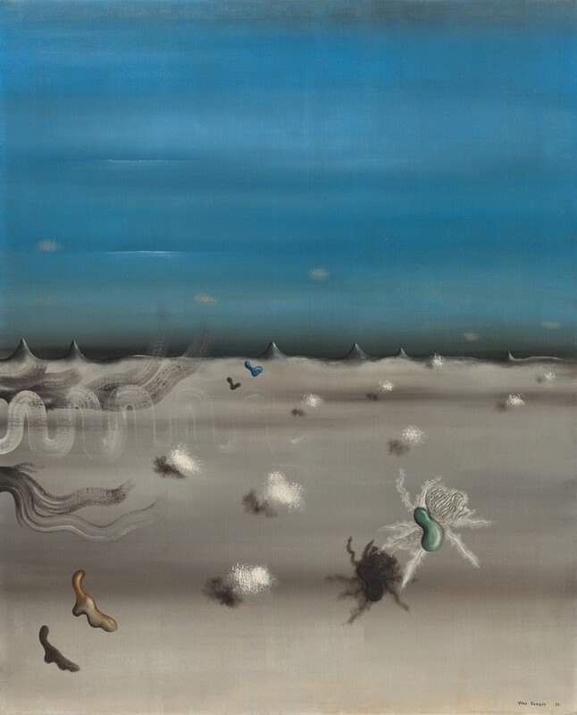 A sky streaked with azure blue stretches over a gray landscape in this surreal, vertical painting. The sky and land meet halfway up the canvas at a series of short, sharp, charcoal-gray peaks, like canine teeth. Small, diffuse, butter-yellow ovals waft above the peaks. Nine fluffy, cotton-ball like shapes cast narrow shadows across the gray-streaked plane. Three amorphous shapes float over the land closer to us. A ginger-brown, drippy form is to our left, a teal-green, bean-shaped object surrounded with fuzzy white tentacles is to our right, and a peacock-blue, L-shaped drip floats in the distance near the horizon. Thinly painted white and gray lines squiggle or sweep onto the canvas from the left edge. The artist signed and dated the painting in the lower right, “Yves Tanguy 29.”