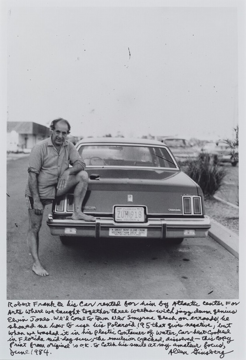Robert Frank & his car rented for him by Atlantic Center For Arts where we taught together three weeks with jazz drum genius Elvin Jones. We’d come to town New Smyrna Beach on errands, he showed me how to use his polaroid 195 that gives negative, but when we washed it in his plastic container of water, car-heat-cooked in Florida mid-day sun, the emulsion cracked, dissolved—this copy print from original is o.k. to catch his smile at my amateur focus, June 1984.
