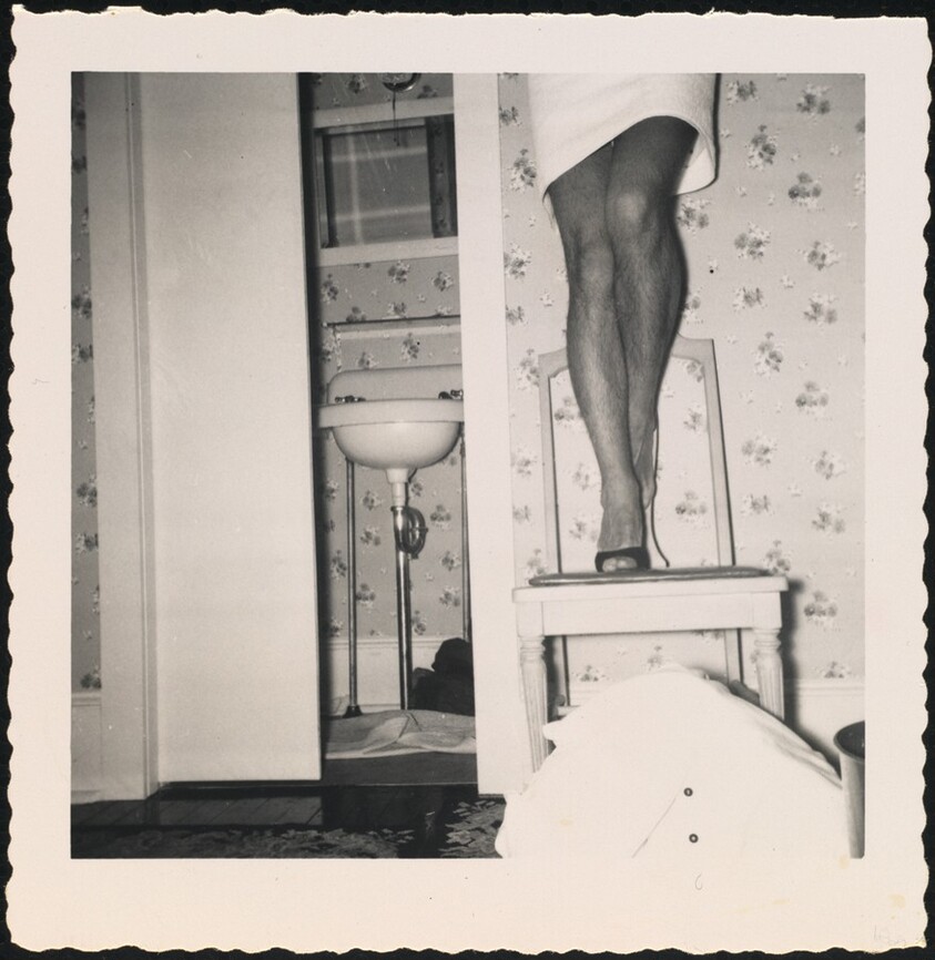 Untitled (Man's legs in skirt on chair)