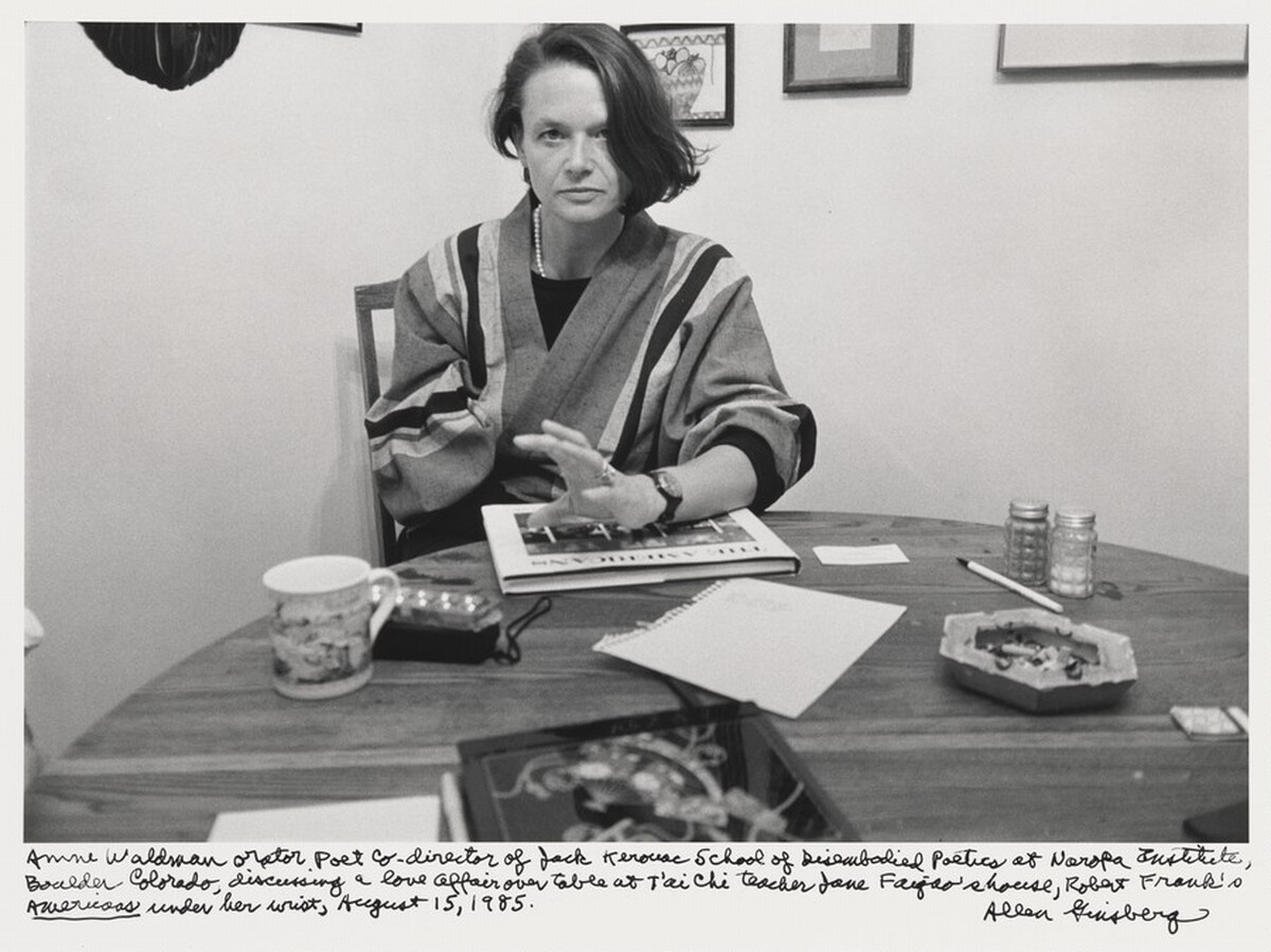 Anne Waldman orator poet co-director of Jack Kerouac School of Disembodied Poetics at Naropa Institute, Boulder Colorado, discussing a love affair over table at T'ai Chi teacher Jane Faigao's house, Robert Frank's _The Americans_ under her wrist, August 15, 1985.