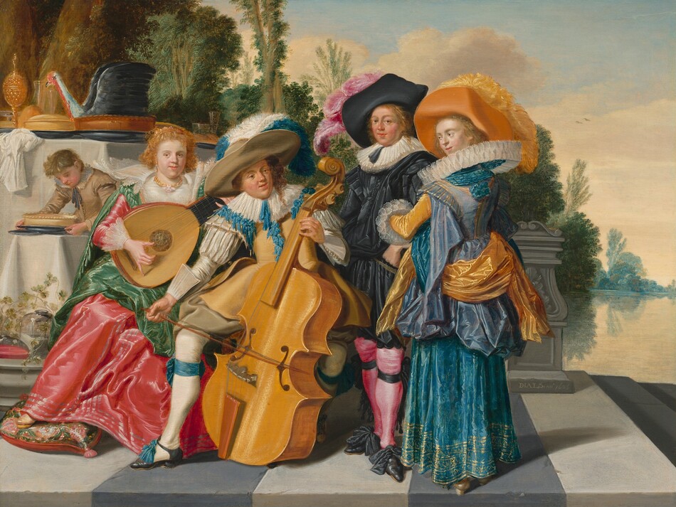 This painting shows four individuals gathered together. They all have light skin and are elaborately dressed. On the far left is a woman with golden curls, a gold necklace, and a crown-like headpiece playing a lute. She wears a vibrant red dress with a white bodice and lace on the sleeves and neckline. On top of it is a green shawl with braided straps. On the right is a man with curly hair wearing a large, tan hat adorned with a white-and-blue plume, a tan doublet with blue feathers or fabric down the middle, tan shorts, and white stockings tied with blue ribbons above blue shoes. He plays a large cello. To the right are two people standing with their arms interlaced. The one on the left is a man with a large black hat with a pink feather, wearing a black shirt with a wide white collar, black shorts, and pink stockings. The woman next to him has an orange hat with a yellow feather and wears a blue gown with a stiff white collar, yellow sleeves, and a yellow sash. The bottom of her dress is embellished with gold. The four people are standing outside on a gray-and-white striped floor. Behind them, on the left, are tables set with white cloths and a lavish feast, including a large golden goblet and the top half of a large bird set atop what looks like a pie crust. A boy dressed in tan garments bends down to pick up a plate from one of the tables. Behind the tables are tall trees with green leaves, and on right is a calm body of water. The sky is light blue and full of white clouds.