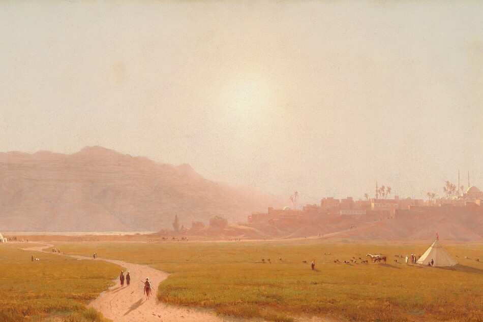 A dirt path winds through a field of gold-green grass back to a town built on low hills in this horizontal, densely hazy landscape painting. Several minuscule people walk on the path and at least one person rides a horse. More people are gathered by a domed, white structure in the distance, where the winding path meets a straighter road leading up into the town near the left edge of the canvas. At least six people sit or stand near a conical white tepee to the right, in the lower quadrant. Two horses and about two dozen smaller animals graze nearby. In the town, the cluster of low, flat-topped buildings, the one domed building with two slender minarets, and palm trees are painted in tones of muted mauve pink and peach. The sun is painted as a hot blaze of light low in the washed-out sky over rocky mountains, which stretch across the left half of the composition. The artist signed and dated the painting with angular red letters in the lower right corner, “S.R. Gifford 1874.”