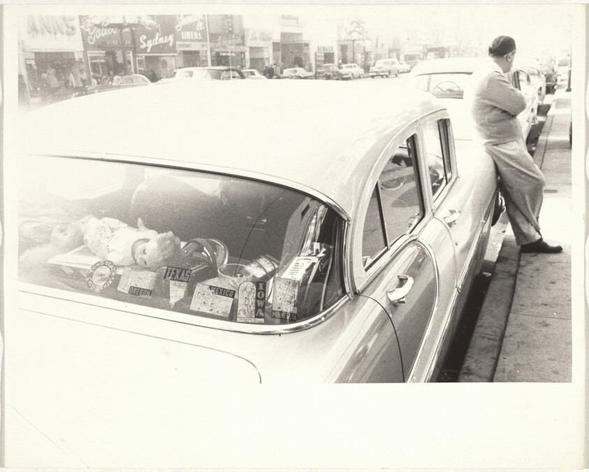 Man leaning against automobile--Hollywood Boulevard