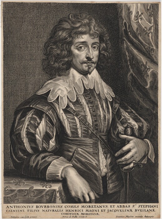 The image shows a man in a three-quarter-length portrait. He is slightly turned to his left with his left hand on his waist and his right hand on the hilt of a sword at his side. The man has distinct facial features including a mustache and goatee. His hair is curly and reaches his neck. He wears a richly adorned garment with a pattern, lace collar, and full sleeves with lace cuffs. The background features a detailed drapery on the right side. The bottom of the image likely contains descriptive text.