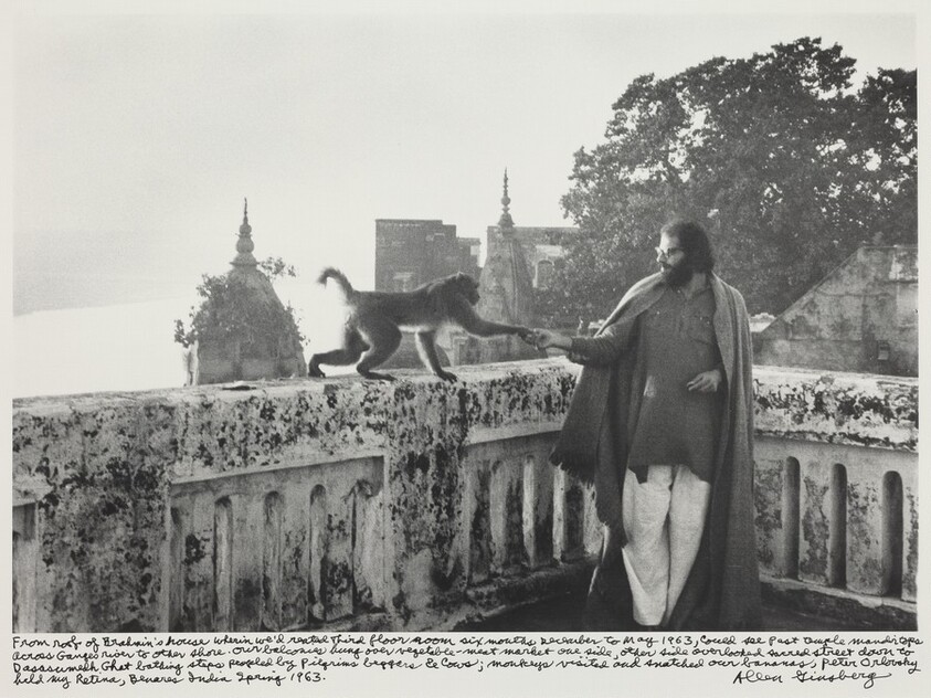 From roof of Brahmin's house wherein we'd rented Third floor room six months December to May 1963, could see past temple mandir tops across Ganges river to other shore. Our balconies hung over vegetable-meat market one side, other side overlooked sacred street down to Dasasumedh [or Dasaswamedh?] Ghat bathing steps peopled by Pilgrims beggars & cows; monkeys visited and snatched our bananas, Peter Orlovsky held my Retina, Benares India Spring 1963.
