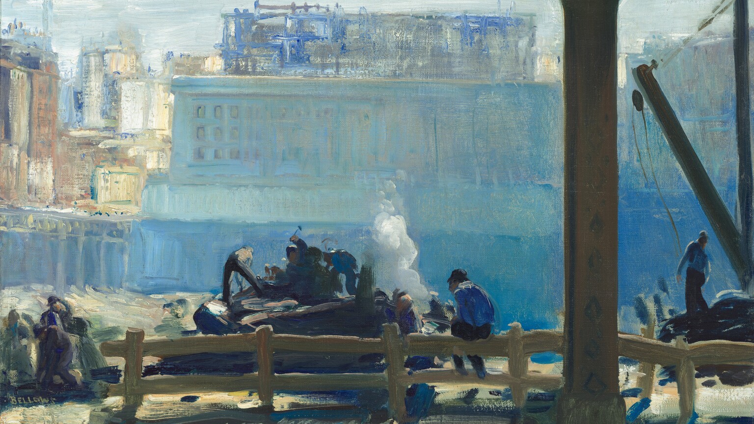 From under an elevated train track, we look at a cluster of people hammering and working on the far side of a wooden fence, all against a silvery-blue building that fills most of the background in this horizontal painting. The scene is loosely painted mostly in tones of hazy and saturated blues, so many of the details are indistinct. About a quarter of the way in from the right edge of the composition, a thin iron column holds up the train platform. The column nearly spans the height of the painting, and the track it supports runs across the top edge of the canvas. At the foot of the column, along the bottom edge, are two parallel tracks embedded in an area otherwise painted with short, diagonal strokes in topaz blue, olive green, and straw yellow. Just beyond the tracks, the split-rail wooden fence runs across most of the painting, though there is an opening at the left edge of the canvas. A man sits with his back to us on the railing to our right of center. He wears a dark cap, a lapis-blue shirt, and navy-blue pants. Several men work on or near a mound-shaped form, perhaps a piece of machinery, just beyond the fence, near the center of the painting. One man holds a hammer high overhead while another reaches down or strikes the mound with his feet planted wide. More people work together to our left, and a man to our right stands near a crane. The people and these areas are painted with broad strokes and touches of cobalt blue, charcoal gray, khaki brown, and a few swipes of shell pink and bright white. A puff of white smoke billows up behind the central group, before the land drops precipitously away. The chasm is painted with shimmering tones of aquamarine and cerulean blue. A sky-blue, rectangular building perches at the far edge. A few windows are outlined in royal blue to our left but the rest of the building is loosely painted with long, vertical strokes so no architectural details can be made out. Behind this structure are more city buildings, suggested with strokes of muted rust red, parchment and bright white, and cobalt blue. The ice-blue sky fills the band between the top of the buildings and the train track running overhead. The artist signed his name near the lower left corner, “BELLOWS.”