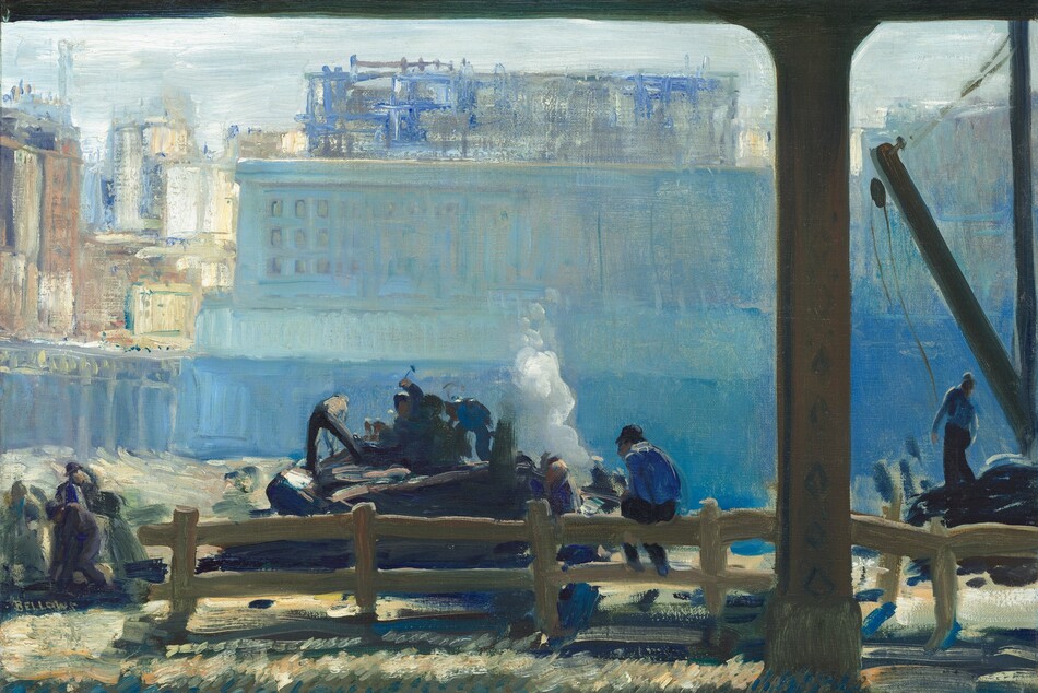 From under an elevated train track, we look at a cluster of people hammering and working on the far side of a wooden fence, all against a silvery-blue building that fills most of the background in this horizontal painting. The scene is loosely painted mostly in tones of hazy and saturated blues, so many of the details are indistinct. About a quarter of the way in from the right edge of the composition, a thin iron column holds up the train platform. The column nearly spans the height of the painting, and the track it supports runs across the top edge of the canvas. At the foot of the column, along the bottom edge, are two parallel tracks embedded in an area otherwise painted with short, diagonal strokes in topaz blue, olive green, and straw yellow. Just beyond the tracks, the split-rail wooden fence runs across most of the painting, though there is an opening at the left edge of the canvas. A man sits with his back to us on the railing to our right of center. He wears a dark cap, a lapis-blue shirt, and navy-blue pants. Several men work on or near a mound-shaped form, perhaps a piece of machinery, just beyond the fence, near the center of the painting. One man holds a hammer high overhead while another reaches down or strikes the mound with his feet planted wide. More people work together to our left, and a man to our right stands near a crane. The people and these areas are painted with broad strokes and touches of cobalt blue, charcoal gray, khaki brown, and a few swipes of shell pink and bright white. A puff of white smoke billows up behind the central group, before the land drops precipitously away. The chasm is painted with shimmering tones of aquamarine and cerulean blue. A sky-blue, rectangular building perches at the far edge. A few windows are outlined in royal blue to our left but the rest of the building is loosely painted with long, vertical strokes so no architectural details can be made out. Behind this structure are more city buildings, suggested with strokes of muted rust red, parchment and bright white, and cobalt blue. The ice-blue sky fills the band between the top of the buildings and the train track running overhead. The artist signed his name near the lower left corner, “BELLOWS.”