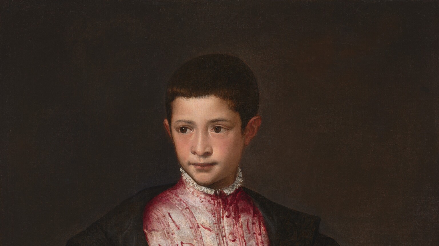 Shown from the hips up, a young boy with pale, peachy skin wears a voluminous, black cloak that nearly falls off his shoulders over a rose-pink tunic, with a sword hanging from one hip in this vertical portrait painting. His body is angled slightly to our right, and he looks off to our left with dark brown eyes under gently arched brows. He has a wide nose, and his pink lips are closed with the corners pulled slightly back. His skin is smooth and his cheeks slightly flushed. His dark brown hair is cut close and comes to a point in front of his ears. His tunic is painted with dusky pink highlights against wine-red to suggest a sheen across a vertically striped, leafy pattern. The garment has a high neck lined with a white ruffle and has a row of buttons down the front. His black coat has wide lapels that reach beyond his shoulders, and the puffy sleeves gather on his arms. The coat has a silvery-white cross over the chest to our right. The left and right arms of the cross are lost in the folds but the arms at the top and bottom are forked at the ends. The boy’s pine-green belt is edged with gold, and the hilt of the sword is angled toward us on his left hip, to our right. He holds one fawn-brown glove in his right hand, to our left, and his other arm disappears behind the folds of his coat. The background is deep olive green, almost brown. The artist signed the painting with dark paint near the right edge of the canvas near the boy’s shoulder, “TITANVS F.”