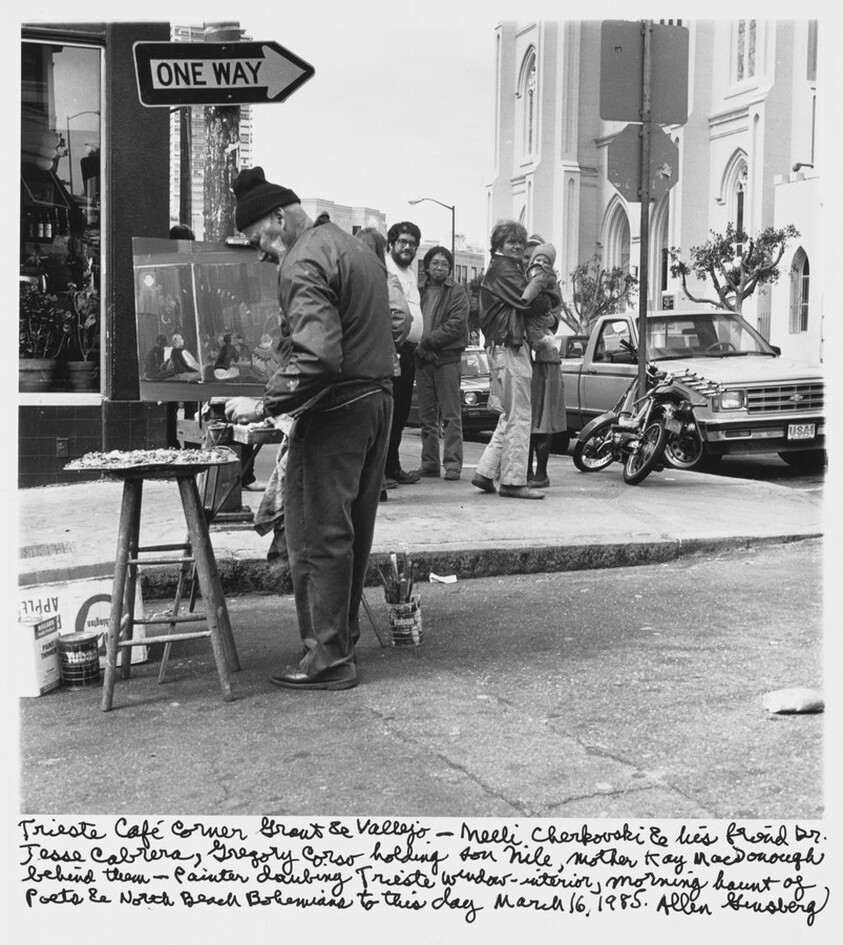 Trieste Cafe corner Grant & Vallejo-- Neeli Cherkovski & his friend Dr. Jesse Cabrera, Gregory Corso holding son Nile, mother Kaye MacDonough behind them-- Painter daubing Trieste window- interior, morning haunt of poets & North Beach Bohemians to this day March 16, 1985.