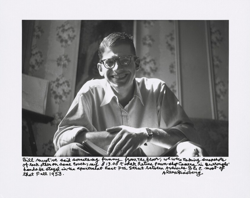 Bill must've said something funny from the floor, we were taking snapshots of each other on same couch, my $13.00 Kodak Retina pawn-shop camera in Burroughs' hands. He stayed in the apartment East 7th Street between Avenues B & C most of that Fall 1953.