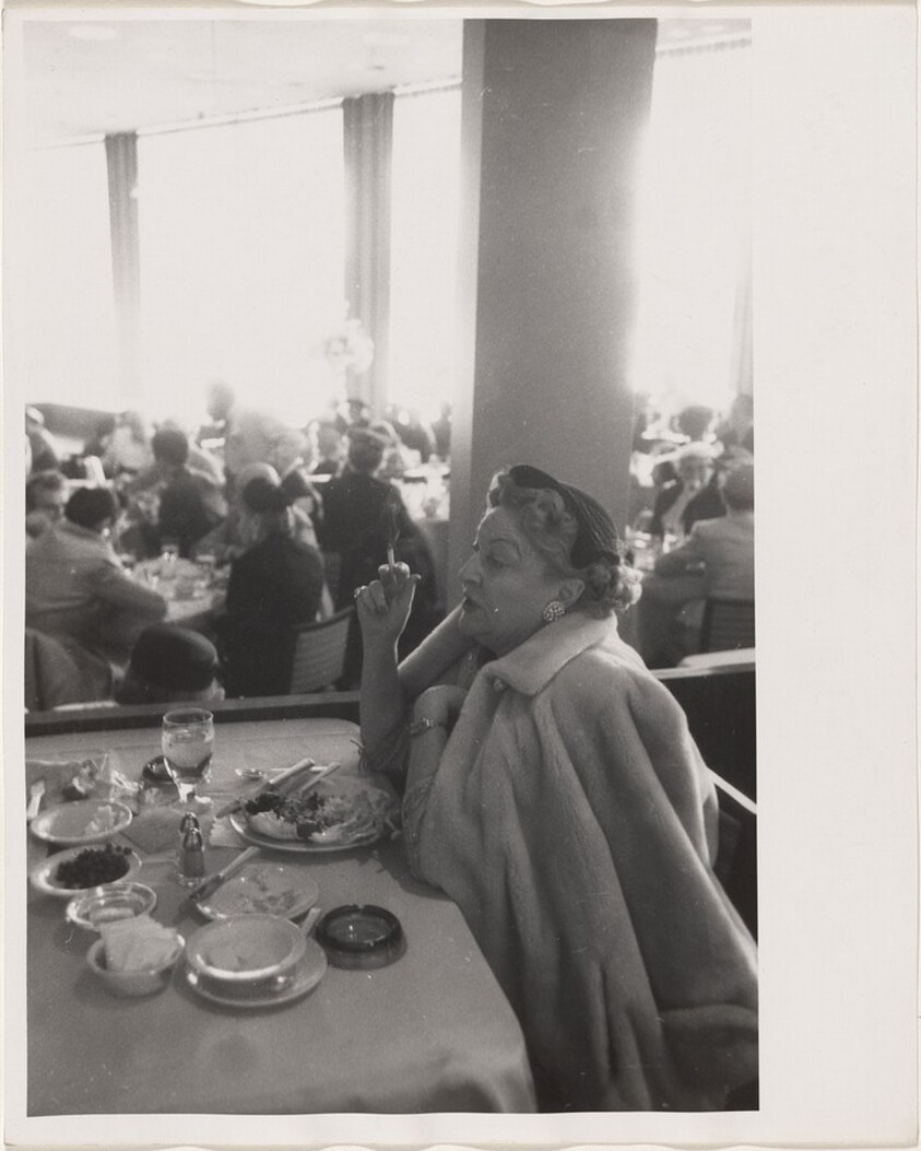 Woman in crowded restaurant--Los Angeles