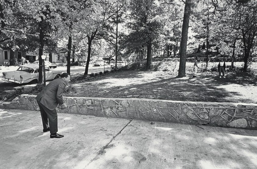 In the front yard of his Atlanta home, Dr. King takes time out for a game of catch with his sons