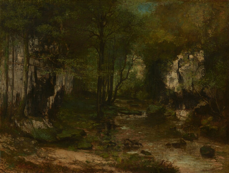 Dense canopies enclose a forested interior along a stream in this horizontal landscape painting. Only a couple small patches of ultramarine-blue sky peek through the canopies, which are painted with dabs and strokes of pine, olive, and spring green. Dark trunks stand straight or curve up through the foliage. The stream begins in the lower right corner of the canvas and moves into the distance along the right half of the composition. Rippling water is painted with shades of muted green, ice blue, and very pale pink. Grassy patches line the dirt ground to the left. The artist signed and dated the painting in the lower left corner, “G. Courbet ’55.”