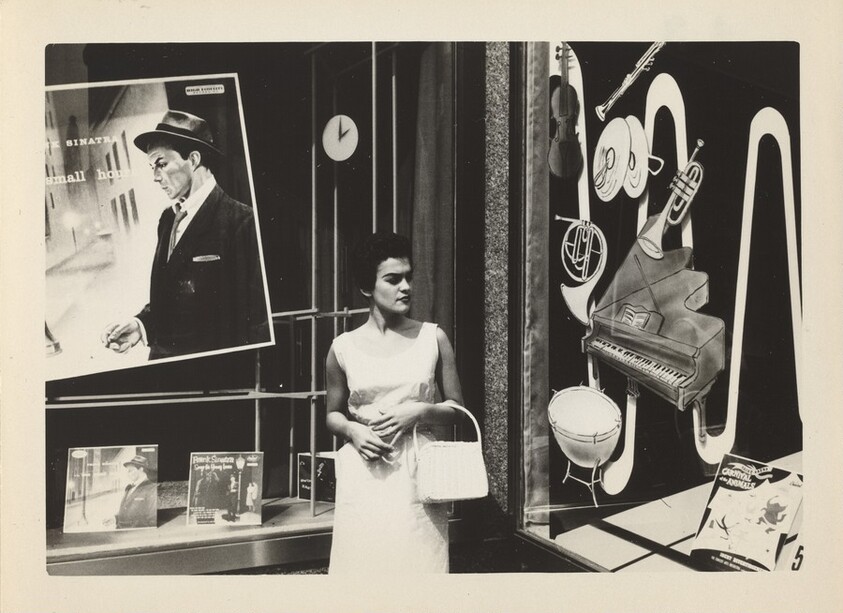 Untitled (Woman standing in front of record store)