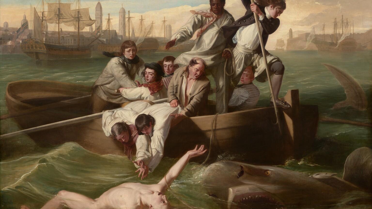 We look onto the side of a rowboat crowded with nine men trying to save a pale, nude young man who flails in the water in front of us as a shark approaches, mouth agape, from our right in this horizontal painting. In the water, the man floats with his chest facing the sky, his right arm overhead and the other stretched out by his side. Extending to our left, his left leg is bent and the right leg is straight, disappearing below the knee. His long blond hair swirls in the water and he arches his back, his wide-open eyes looking toward the shark behind him. To our right, the shark rolls up out of the water with its gaping jaws showing rows of pointed teeth. In the boat, eight of the men have light or tanned complexions, and one man has dark brown skin. The man with brown skin stands at the back center of the boat, and he holds one end of a rope, which falls across the boat and around the upper arm of the man in the water. Another man stands at the stern of the boat, to our right, poised with a long, hooked harpoon over the side of the boat, ready to strike the shark. His long dark hair blows back and he wears a navy-blue jacket with brass buttons, white breeches, blue stockings, and his shoes have silver buckles. Two other men wearing white shirts with blousy sleeves lean over the side of the boat, bracing each other as they reach toward the man in the water. An older, balding man holds the shirt and body of one of this pair and looks on, his mouth open. The other men hold long oars and look into the water with furrowed brows. The tip of a shark’s tail slices through the water to our right of the boat, near the right edge of the canvas. Along the horizon line, which comes three-quarters of the way up the composition, buildings and tall spires line the harbor. The masts of boats at port creates a row of crosses against the light blue sky. Steely gray clouds sweep across the upper left corner of the canvas and the sky lightens to pale, butter yellow at the horizon.
