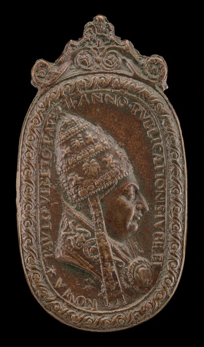 The sculpture is a relief portrait of a figure wearing a papal tiara. The head of the figure is in profile, facing to the right. The sculpture is made of a material with a bronze-like appearance, showing a patina that gives it a greenish hue mixed with bronze. The figure’s face is detailed, featuring prominent facial features, and the tiara has intricate decoration. The sculpture is surrounded by an ornate border with floral and scroll-like patterns, and inscriptions in Latin are visible around the portrait. The design highlights the subject's significance with high-relief detailing and decorative embellishments.