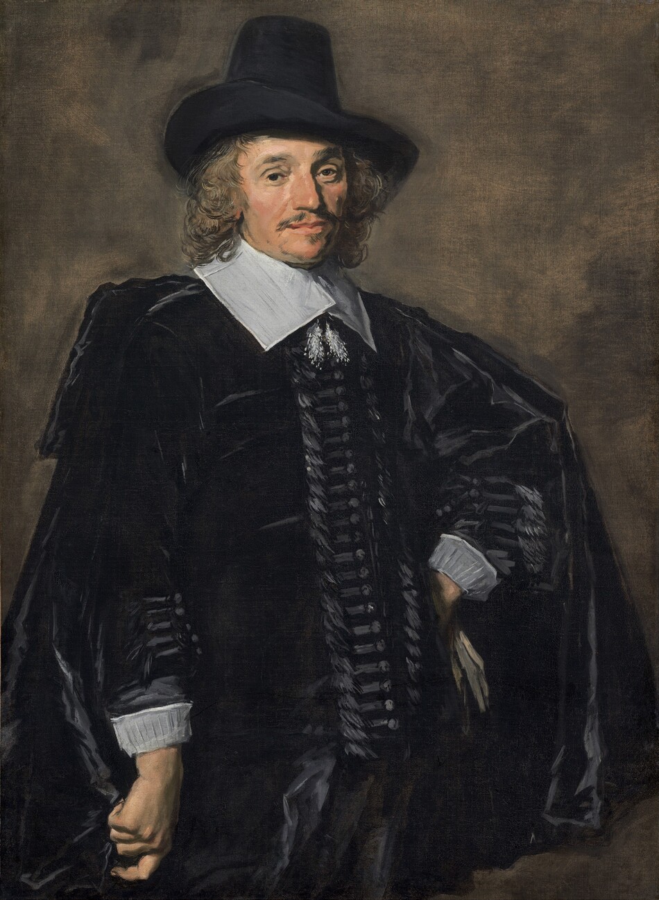Shown from the thighs up, a man with pale, peachy skin, wearing a black suit, cape, and hat, stands with one hand on his hip against an elephant-gray background in this vertical portrait painting. The portrait is loosely painted in some areas, especially in the clothing and background, though the face is more detailed. His body is angled slightly to our right so one shoulder juts toward us, to our left, and he turns his face to look at us brown eyes. One bushy brow is slightly arched. He has a long, bumped nose, soft jowls along his jawline, and perhaps a mole almost lost in shadow on his left cheek, to our right. His wide, pale peach lips are closed and framed by a thin, brushy mustache and a patch of hair under his lower lip. His shoulder-length, wavy, light brown hair curls around his face, and he wears a tall, black hat with a wide brim turned over his right ear, to our left. A hip-length black cloak drapes over a long-sleeved black jacket. A wide, flat, white collar lies across his shoulders and is tied with fluffy tassels that hang on his chest. Streaks of slate-gray suggest horizontal bands next to buttons down the front of his jacket and along the forearms, above white cuffs. He stands with his right arm, to our left, hanging by his side, and he holds the fabric of his cloak in a loose fist. The back of his other hand rests against his left hip, to our right, and a few streaks of parchment brown suggest a glove in that hand. The background is painted with thin, blended areas of gray and peanut brown.