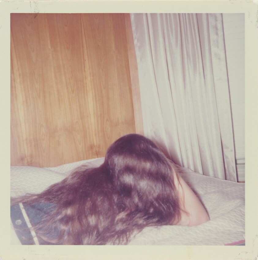 Untitled (Girl lying on bed with long hair covering back)